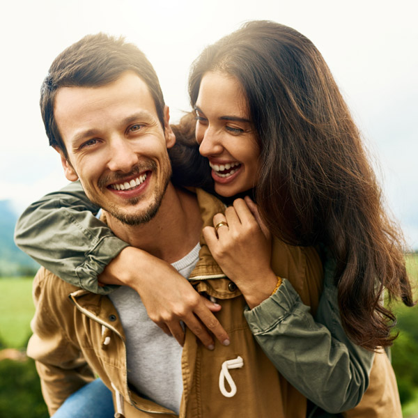 couple smiling together outside