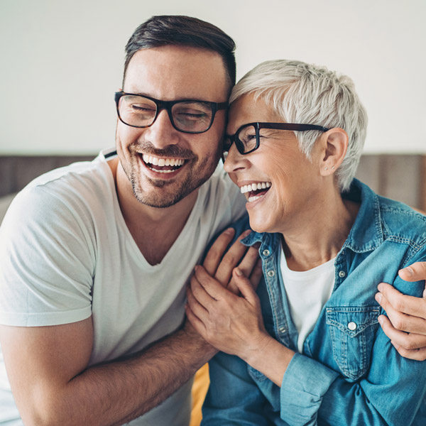 older son and mature mom laughing together