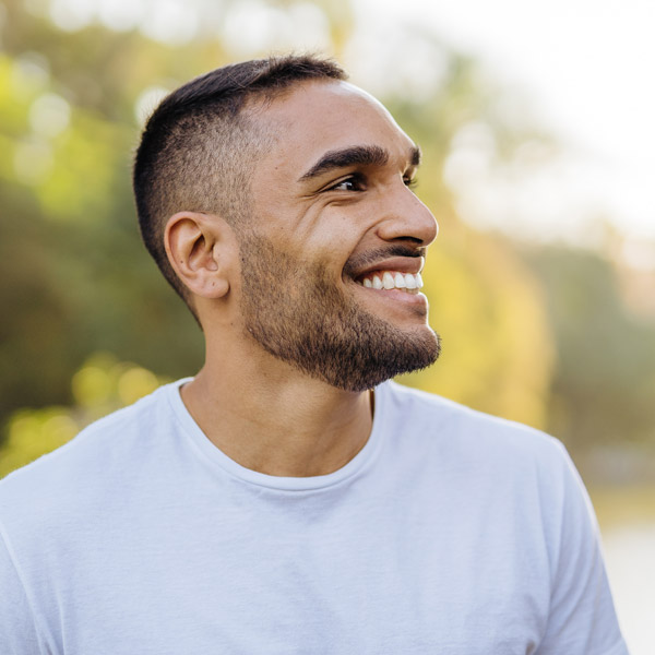 man smiling outside looking right