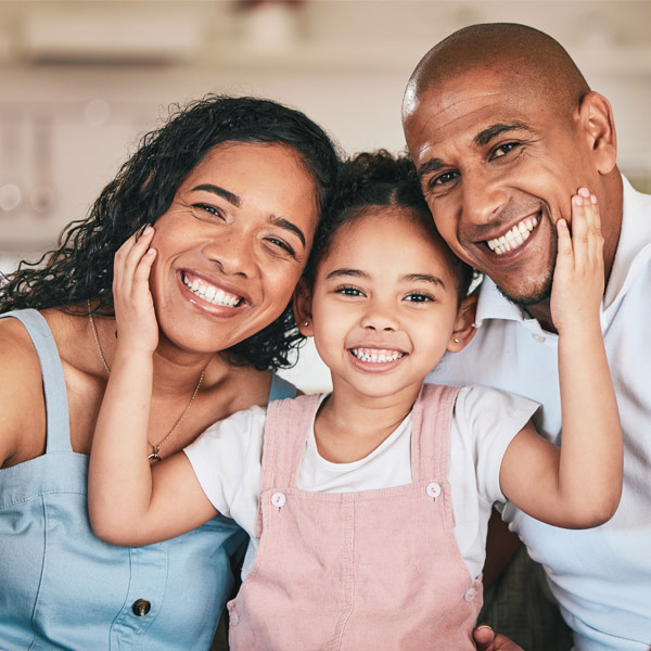 family of three smiling together