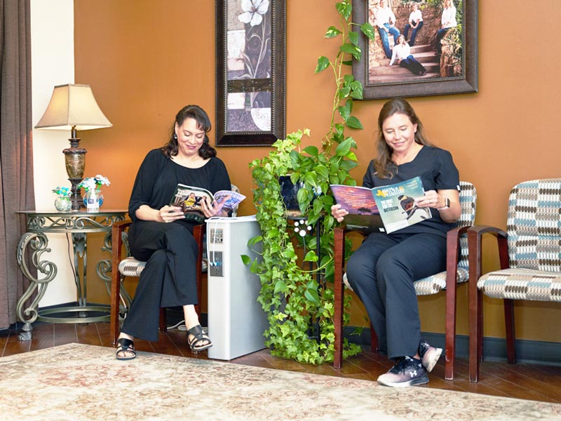 patients in waiting room reading magazines